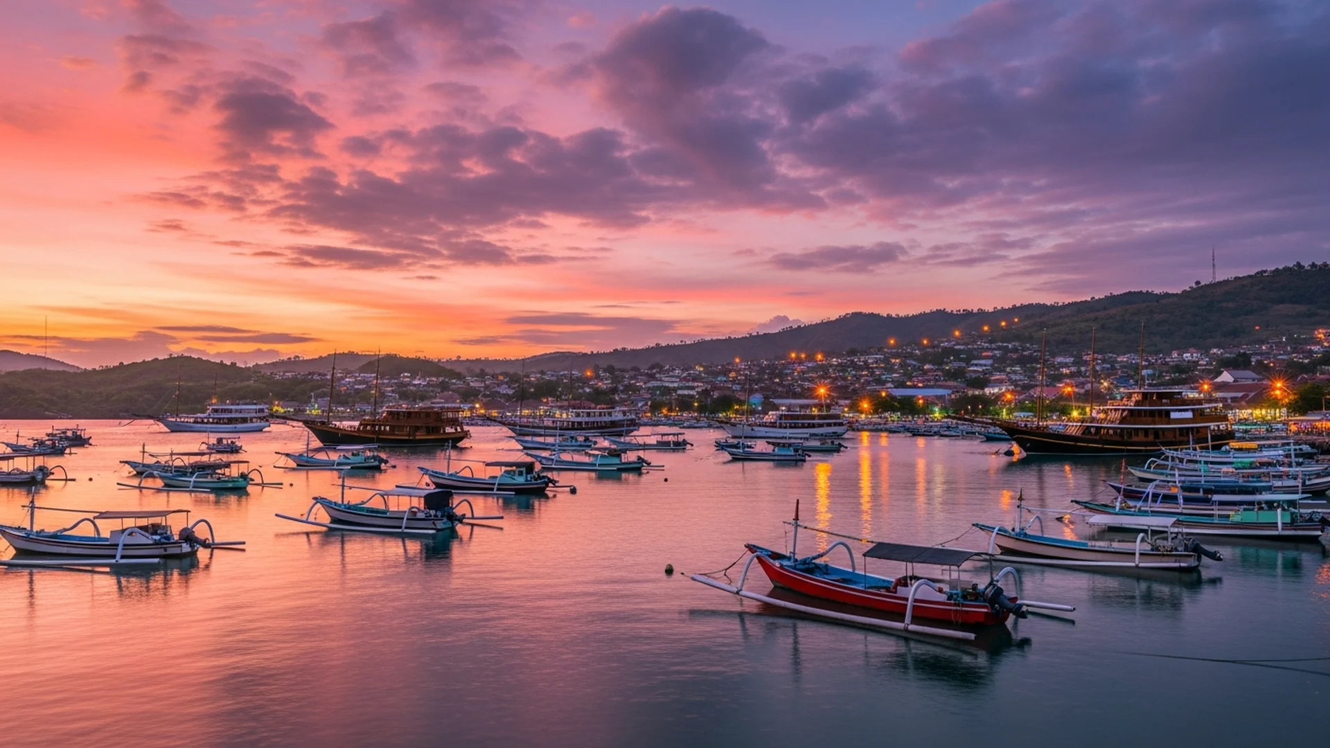 Labuan Bajo harbor sunset with phinisi yachts
